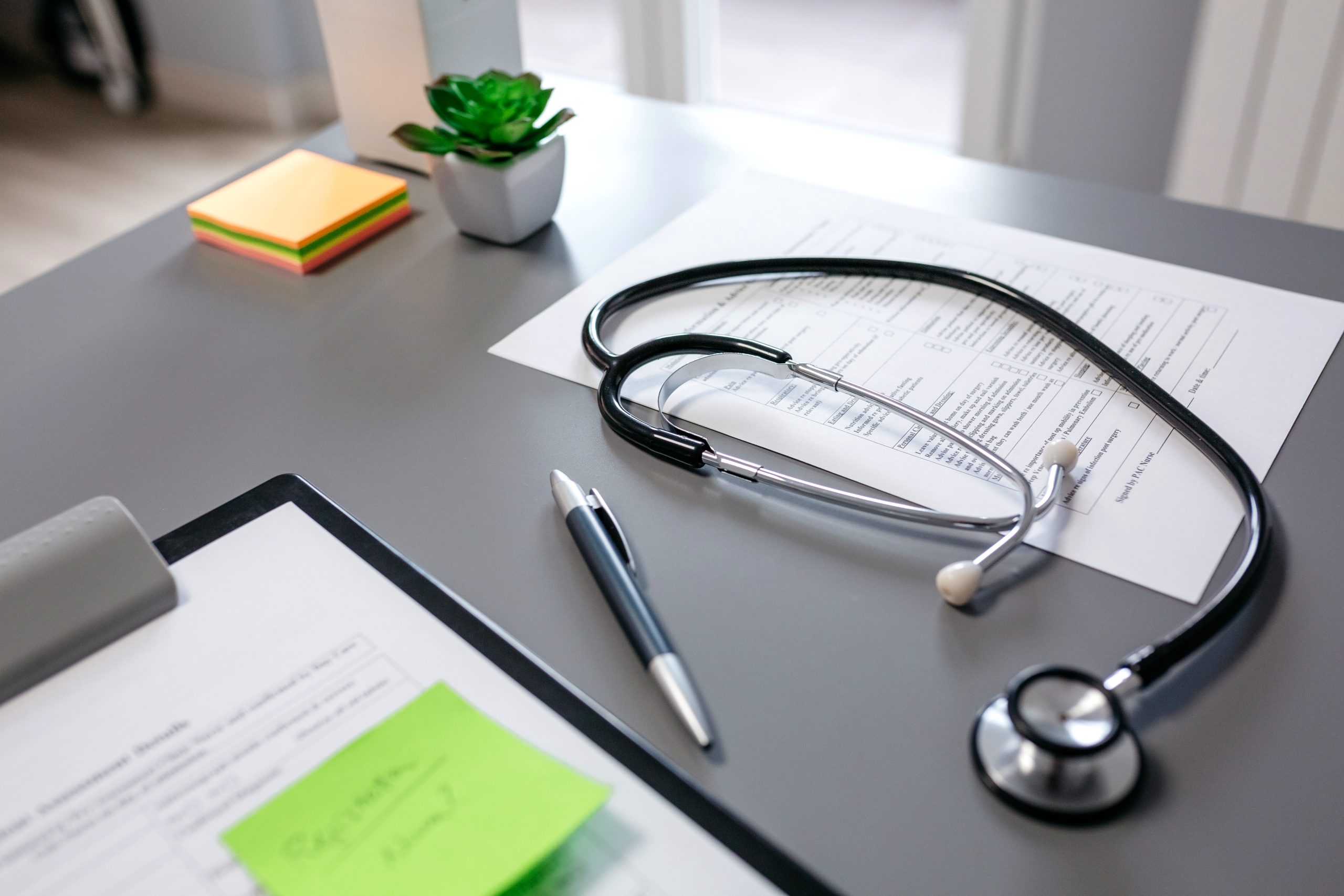 Doctor desk with stethoscope and medical documents